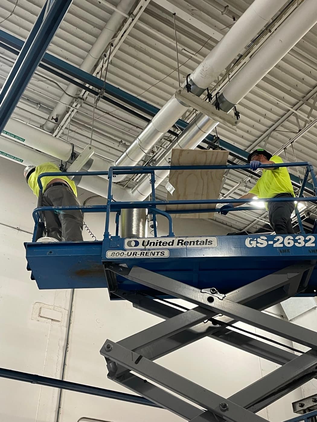 Overhead work from a scissor lift