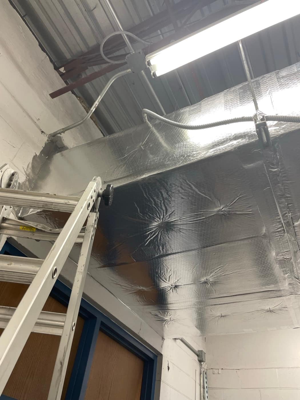 Duct wrap seams taped along wall