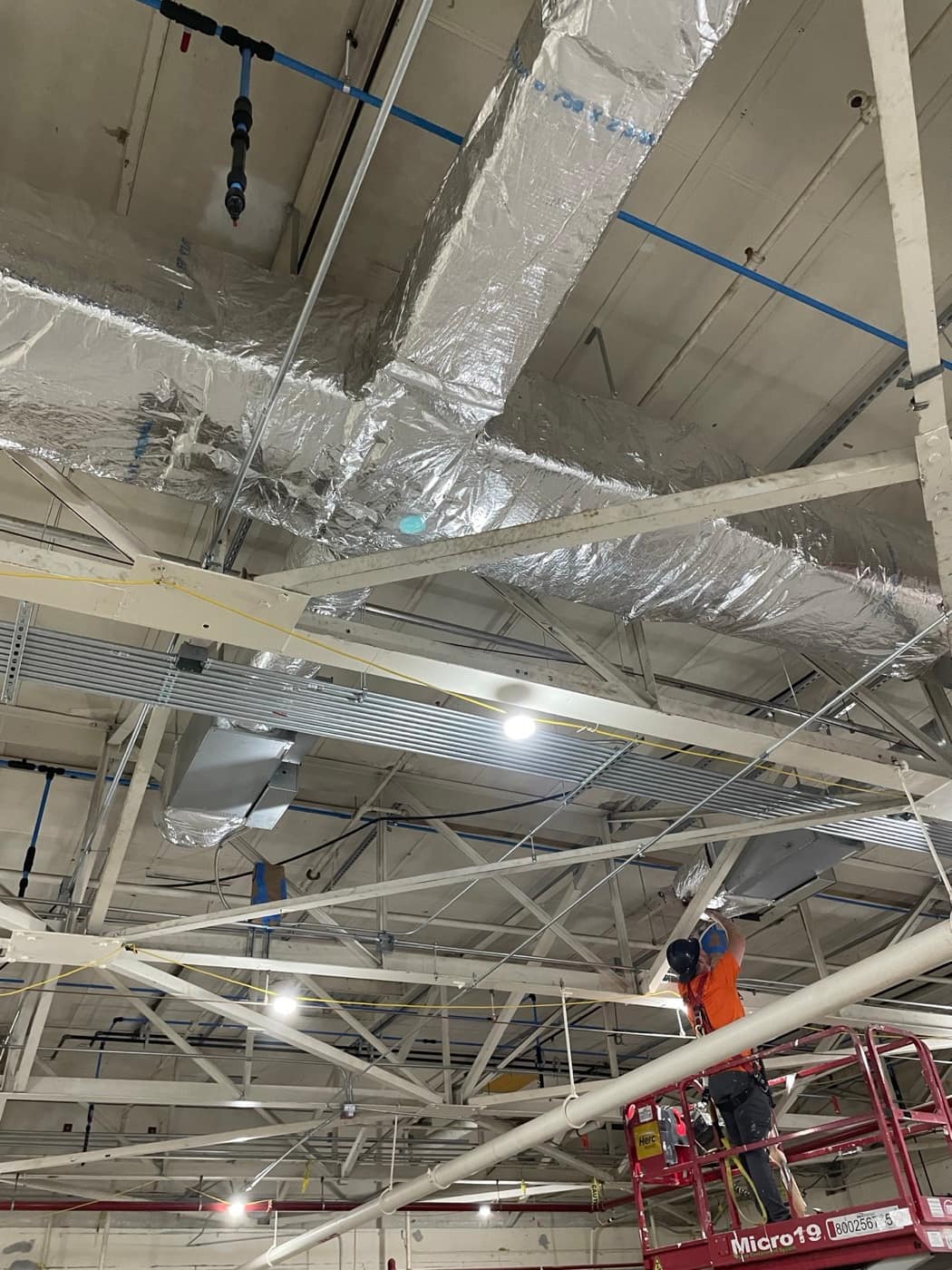 Duct mains across bar joists