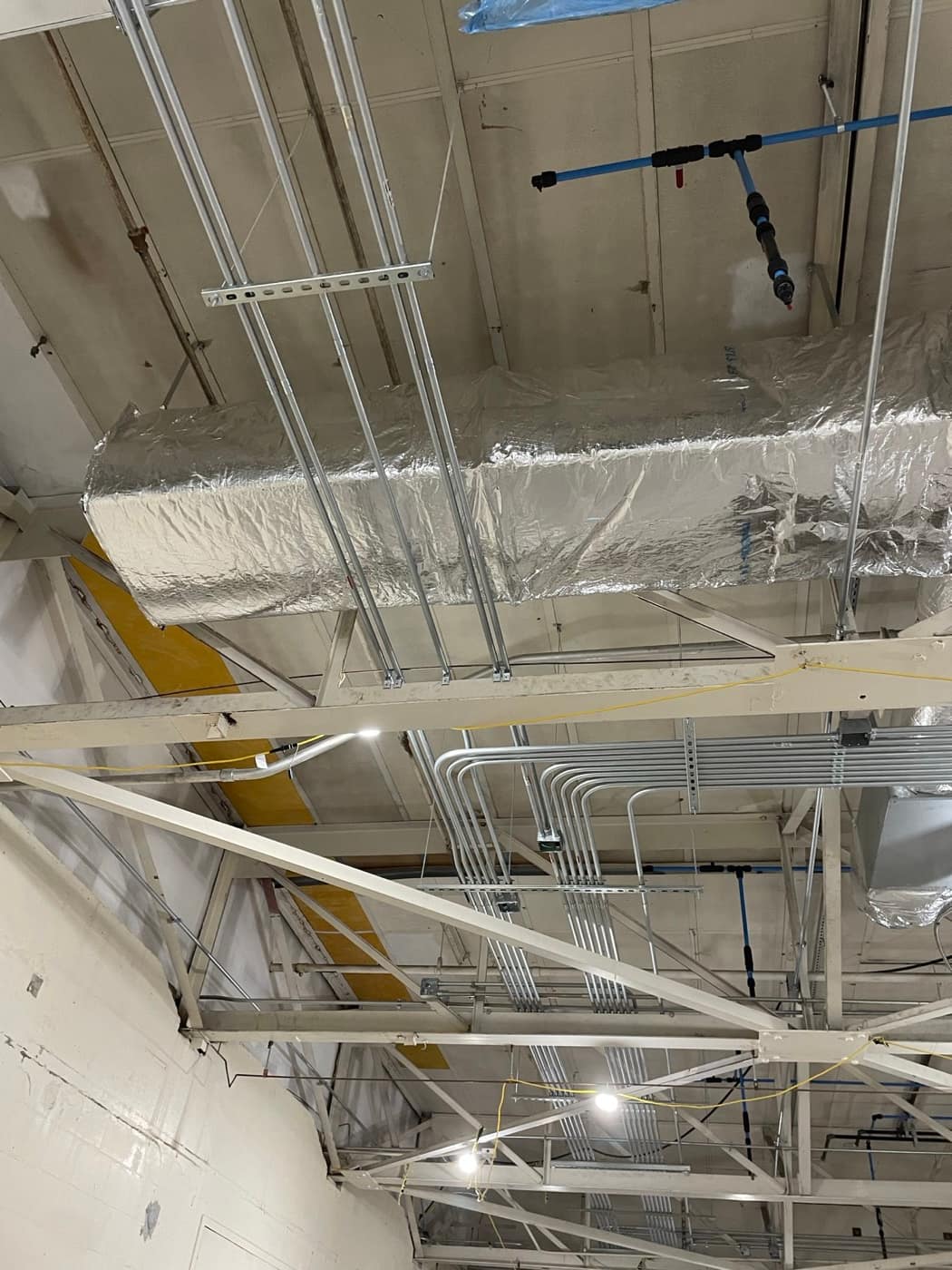 Rectangular duct above conduit racks