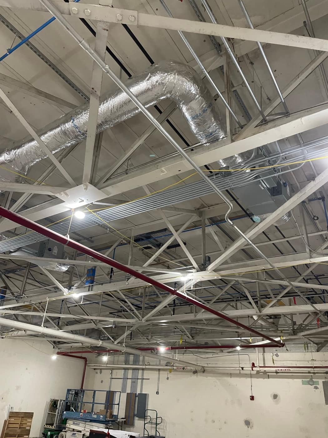 Flex duct above open bar joists
