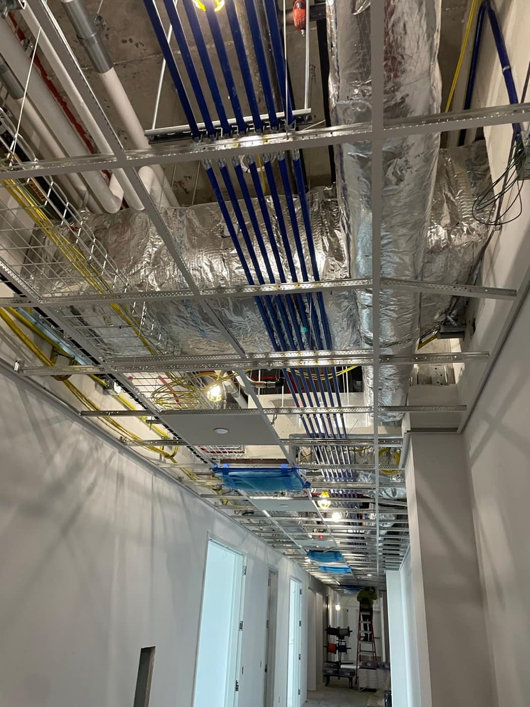 Foil faced duct runs over grid