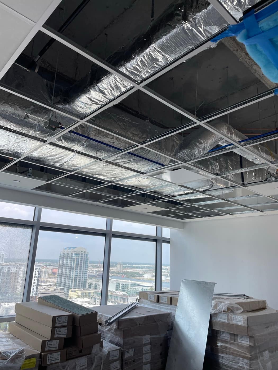 Duct above office ceiling grid