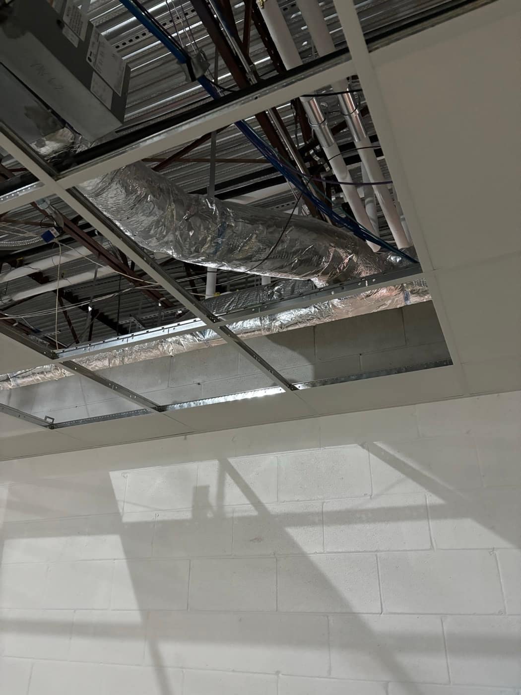 Flex duct above open ceiling tiles